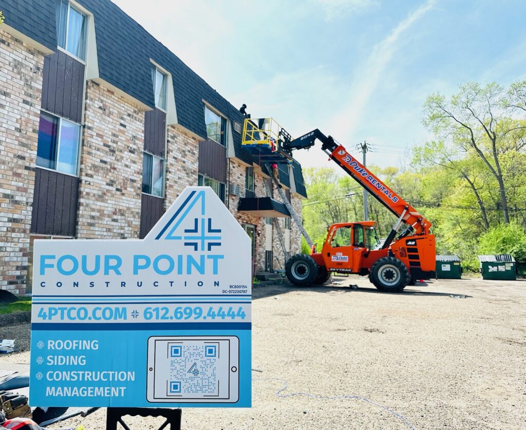 Four Point Construction crew replacing a roof on a Twin Cities building